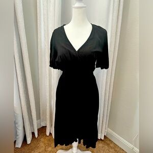 Kernel black dress with elastic waist, plunging neck line.